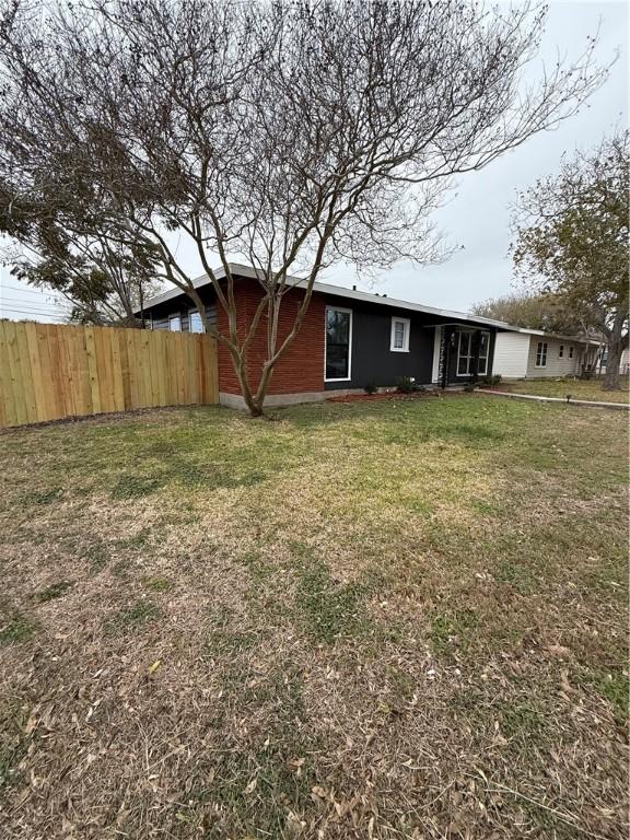 rear view of house with a yard