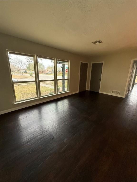 spare room with dark hardwood / wood-style floors