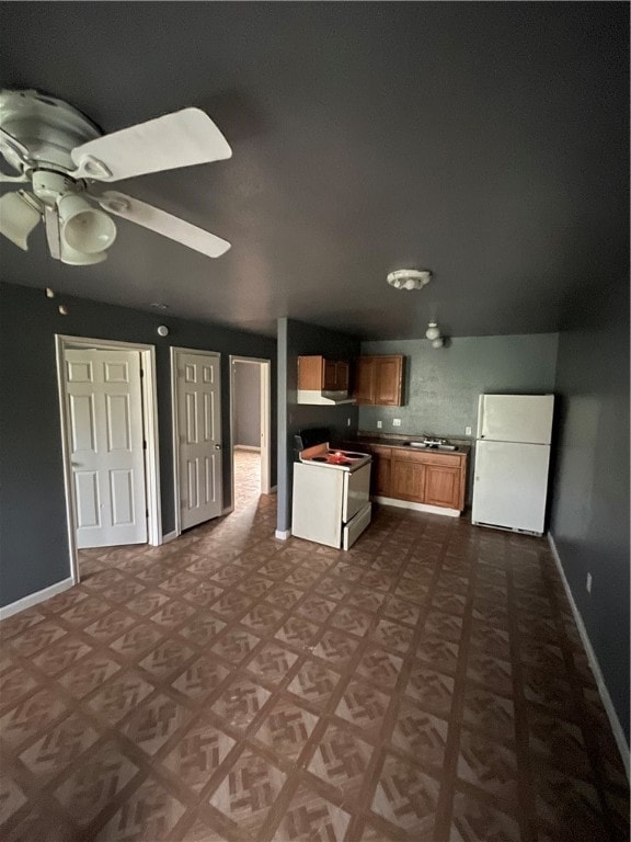 kitchen with white appliances and ceiling fan