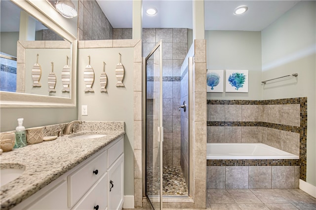 bathroom with plus walk in shower, vanity, and tile patterned flooring