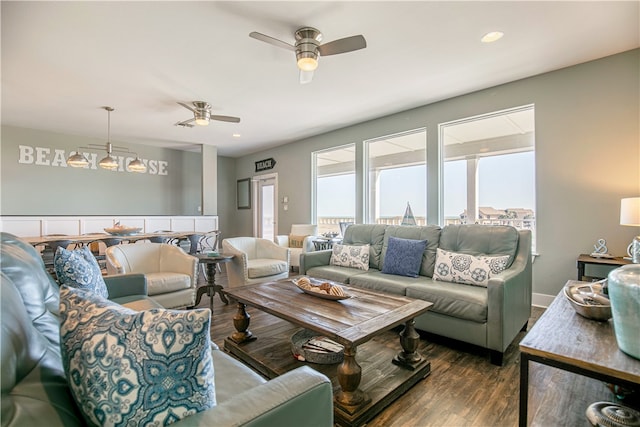 living room with dark hardwood / wood-style flooring and ceiling fan