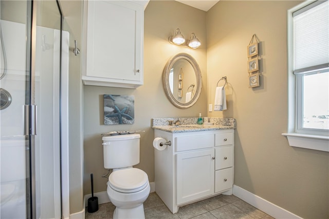 bathroom with walk in shower, vanity, toilet, and tile patterned floors