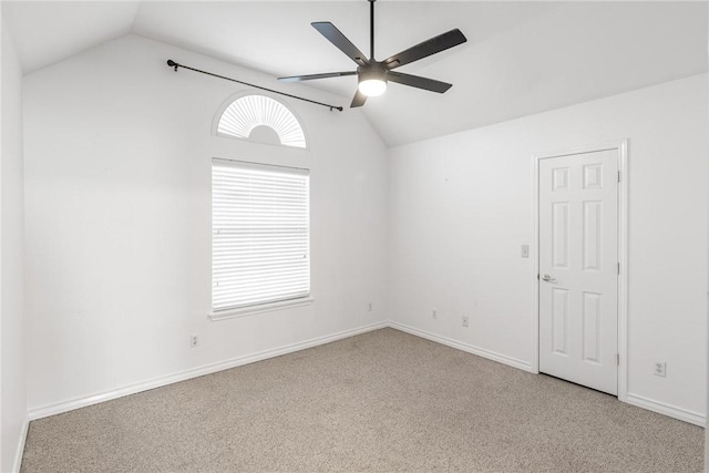 carpeted spare room with ceiling fan and lofted ceiling