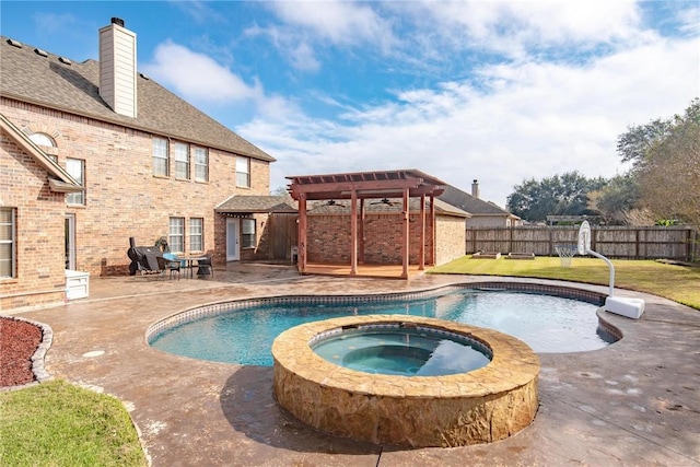 view of pool with an in ground hot tub, a pergola, a patio area, and a lawn