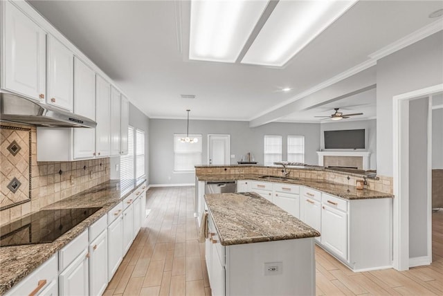 6137 Lemans Dr, Corpus Christi, TX 78414 - kitchen featuring black electric cooktop, under cabinet range hood, a center island, backsplash, and recessed lighting