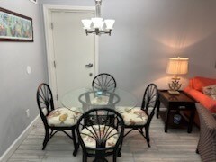 dining room with an inviting chandelier and wood-type flooring