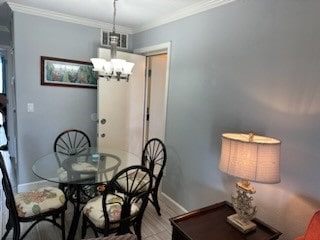 dining space with crown molding and an inviting chandelier