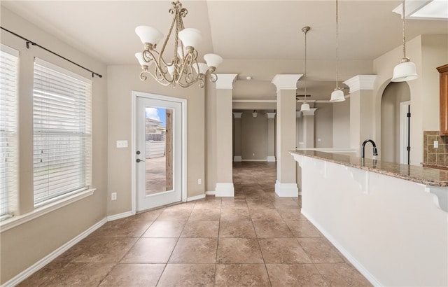 7418 Bar T Dr, Corpus Christi, TX 78414 - kitchen featuring a kitchen breakfast bar, pendant lighting, light stone countertops, a chandelier, and arched walkways