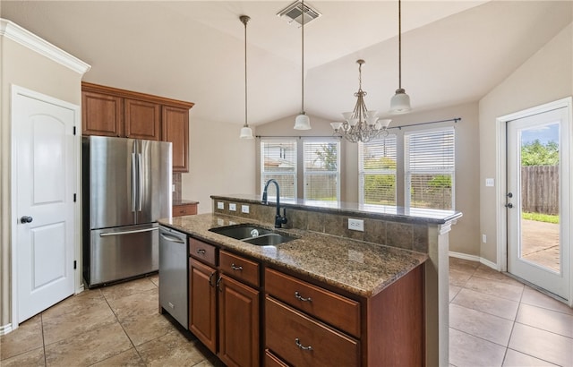7418 Bar T Dr, Corpus Christi, TX 78414 - kitchen featuring stainless steel appliances, lofted ceiling, decorative light fixtures, a kitchen island with sink, and dark stone countertops