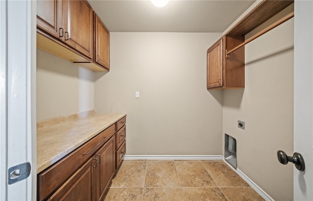 7418 Bar T Dr, Corpus Christi, TX 78414 - laundry room featuring hookup for an electric dryer, cabinet space, and light stone finish flooring