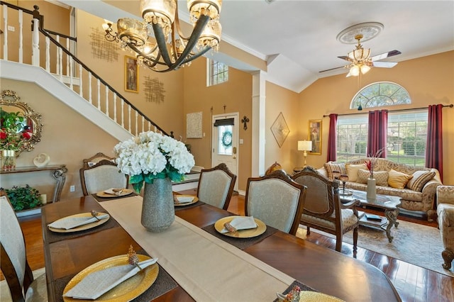 7425 Bourget Dr, Corpus Christi, TX 78413 - dining area with wood finished floors, a ceiling fan, a chandelier, stairway, and crown molding