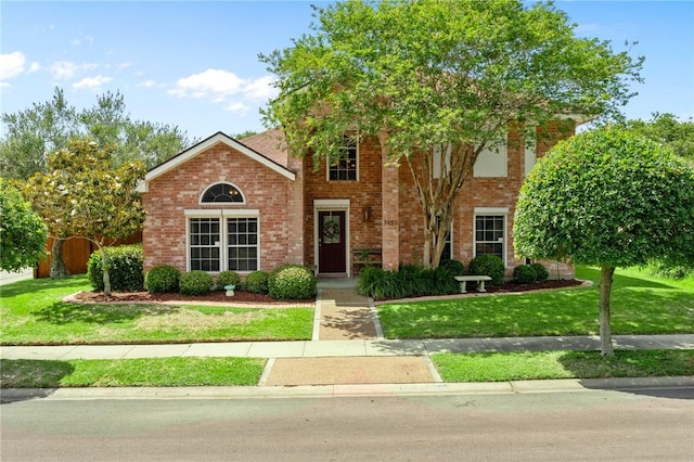 7425 Bourget Dr, Corpus Christi, TX 78413 - view of front of home with a front yard and brick siding