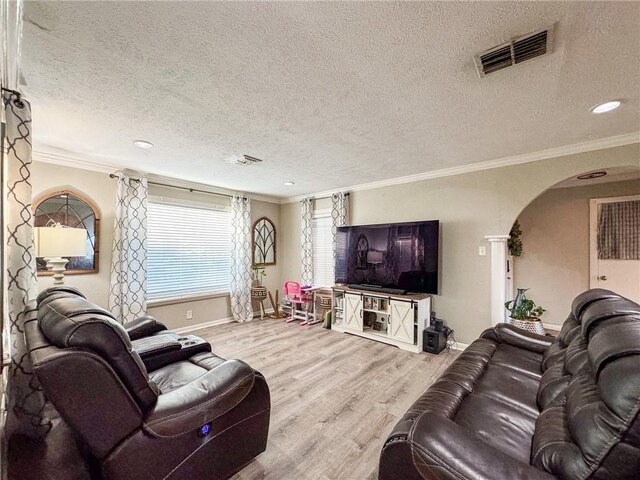 447 Santa Monica Pl, Corpus Christi, TX 78411 - living area with arched walkways, wood finished floors, crown molding, a textured ceiling, and baseboards
