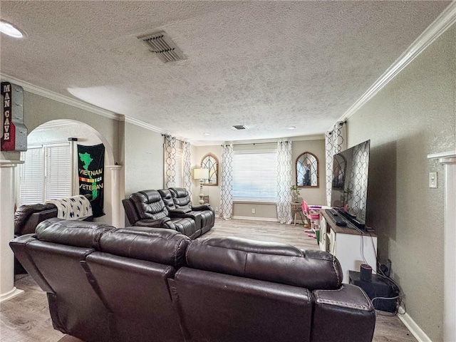 447 Santa Monica Pl, Corpus Christi, TX 78411 - living area with wood finished floors, arched walkways, ornamental molding, baseboards, and a textured ceiling