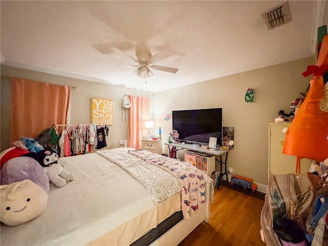 447 Santa Monica Pl, Corpus Christi, TX 78411 - bedroom with crown molding, dark wood finished floors, baseboards, and a ceiling fan