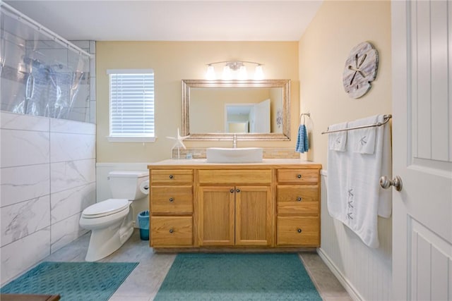 bathroom featuring a shower, tile patterned floors, vanity, and toilet