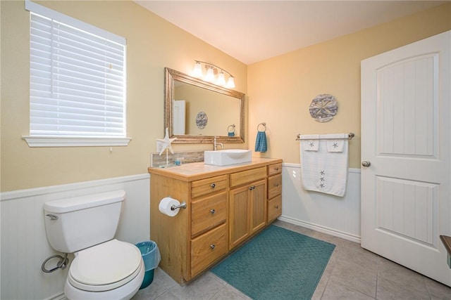 bathroom with tile patterned floors, vanity, and toilet