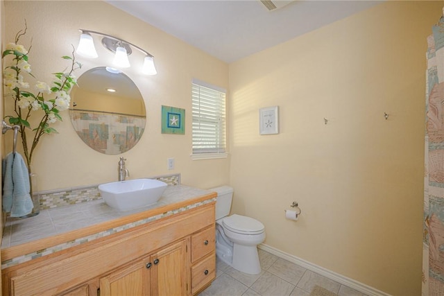 bathroom featuring tile patterned floors, vanity, and toilet