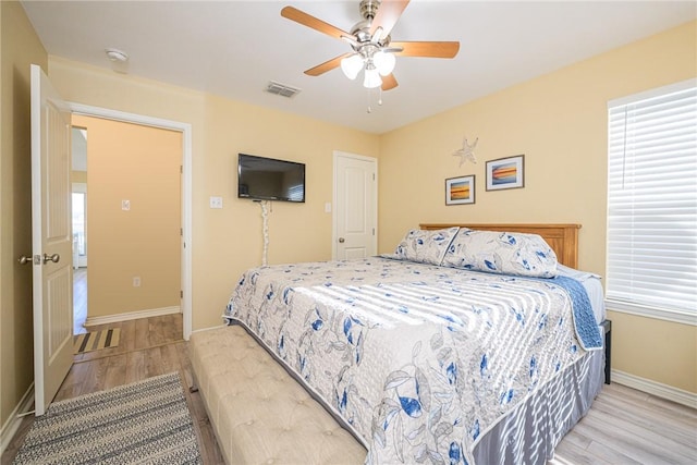 bedroom with ceiling fan and light hardwood / wood-style flooring