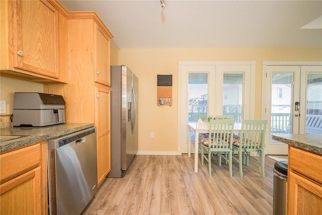 kitchen featuring light hardwood / wood-style floors, stainless steel appliances, and french doors