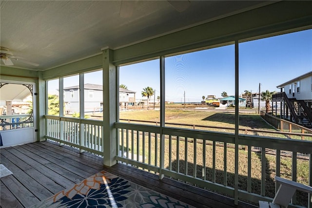 sunroom featuring ceiling fan