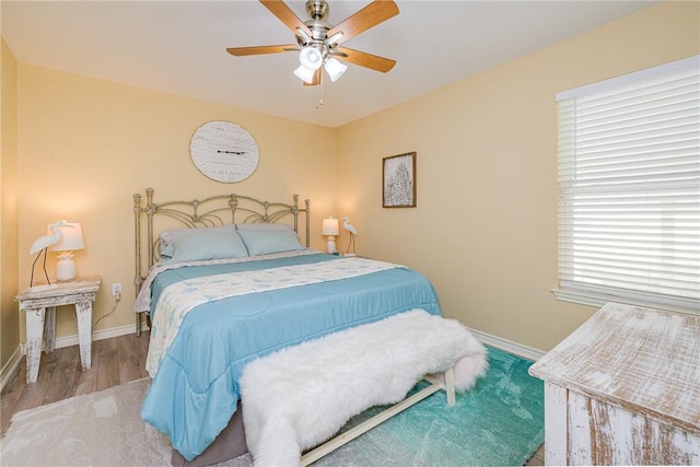 bedroom featuring ceiling fan and wood-type flooring