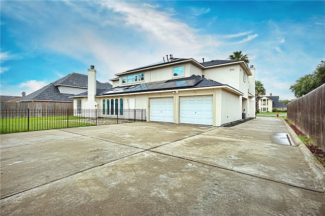 back of house featuring a garage