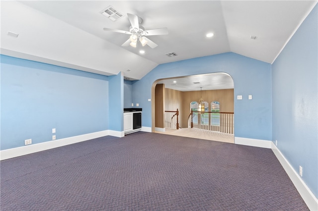 unfurnished living room featuring ceiling fan with notable chandelier, lofted ceiling, and carpet