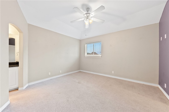 spare room featuring light colored carpet and ceiling fan