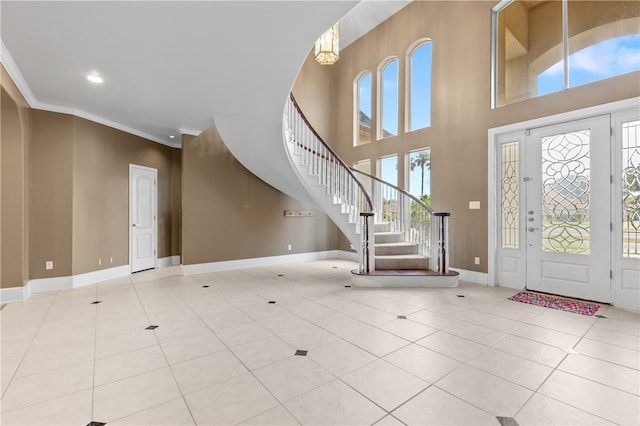 entryway featuring ornamental molding, plenty of natural light, and light tile patterned floors