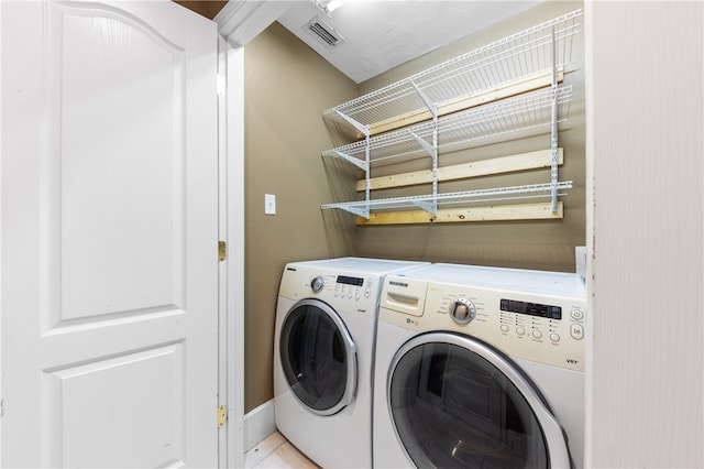 laundry room featuring washer and clothes dryer