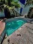 view of pool with a jacuzzi