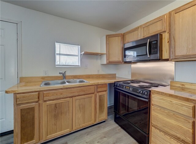 kitchen featuring butcher block counters, light brown cabinetry, sink, black range oven, and light hardwood / wood-style flooring