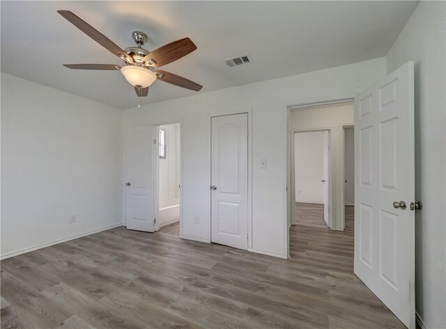 unfurnished bedroom featuring light hardwood / wood-style flooring and ceiling fan