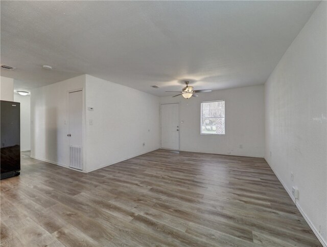 spare room featuring light hardwood / wood-style floors and ceiling fan