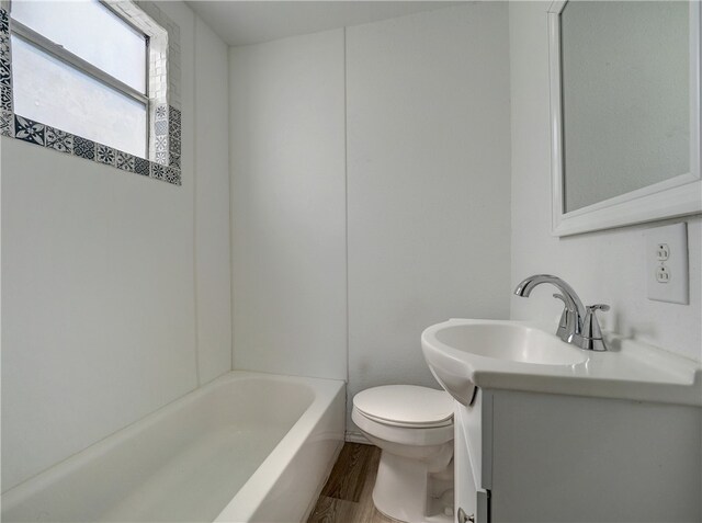 full bathroom featuring shower / bathing tub combination, vanity, hardwood / wood-style flooring, and toilet