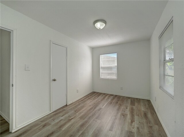 spare room featuring light wood-type flooring