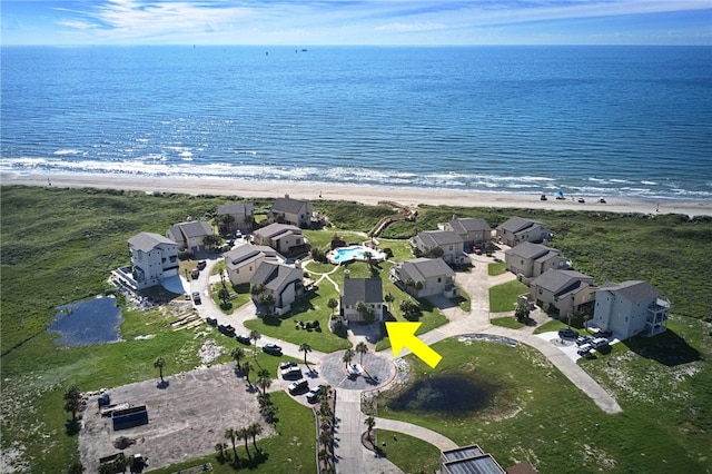 bird's eye view featuring a beach view and a water view