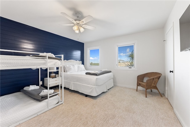 bedroom featuring light colored carpet and ceiling fan