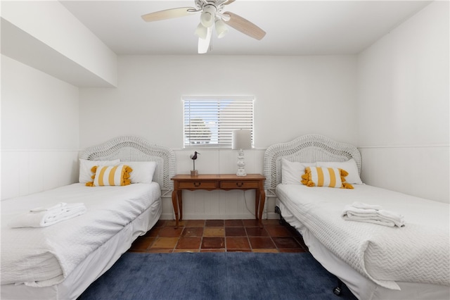 bedroom with ceiling fan and dark tile patterned floors