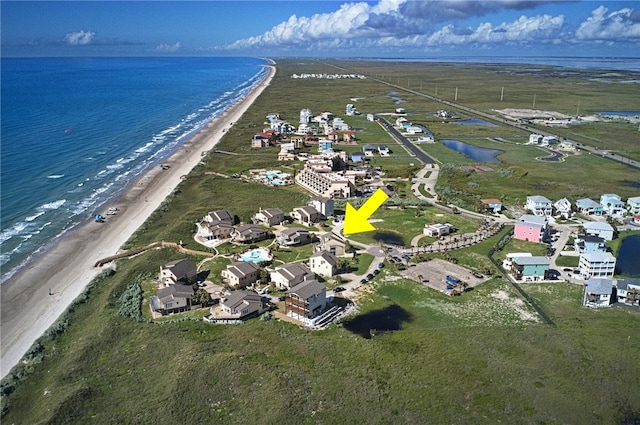 birds eye view of property featuring a view of the beach and a water view