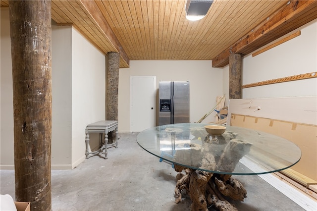 dining room with wooden ceiling and concrete flooring