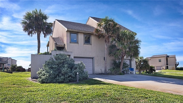 view of front of house featuring a garage and a front lawn