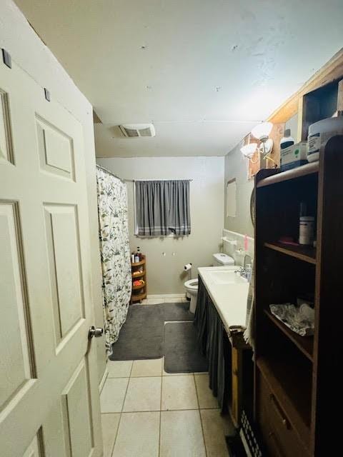 bathroom with tile patterned floors, vanity, and toilet