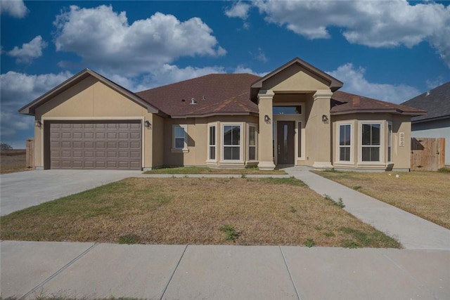 view of front of house featuring a garage and a front yard