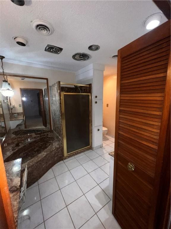 5445 Ocean Dr, Corpus Christi, TX 78412 - bathroom with a stall shower, a textured ceiling, ornamental molding, tile patterned flooring, and vanity
