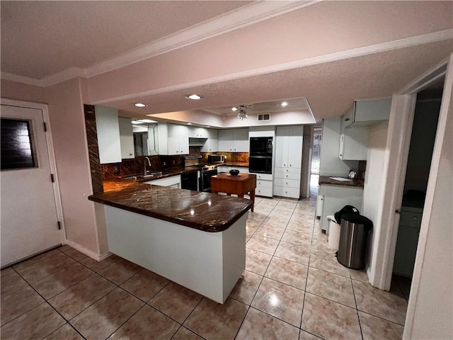 5445 Ocean Dr, Corpus Christi, TX 78412 - kitchen with a tray ceiling, crown molding, electric range, dark countertops, and stainless steel microwave
