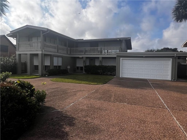 5445 Ocean Dr, Corpus Christi, TX 78412 - rear view of house featuring driveway, a garage, and a balcony