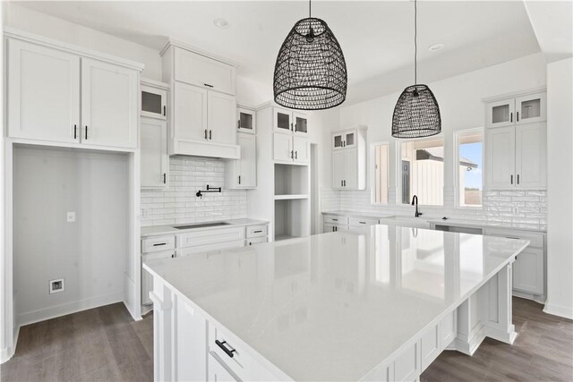 kitchen featuring white cabinetry, glass insert cabinets, backsplash, and recessed lighting