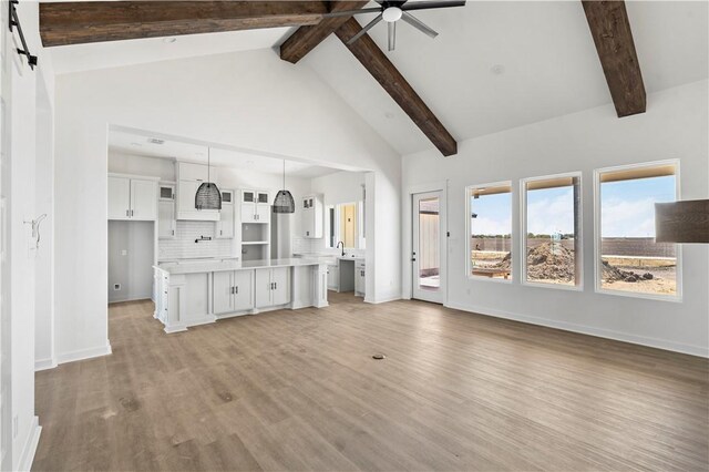 bonus room with vaulted ceiling with beams and baseboards